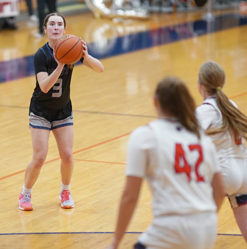 Oswego East's Maggie Lewandowski (3) spots up for a three pointer against Oswego during a basketball game at Oswego High School on Tuesday, Dec 12, 2023.