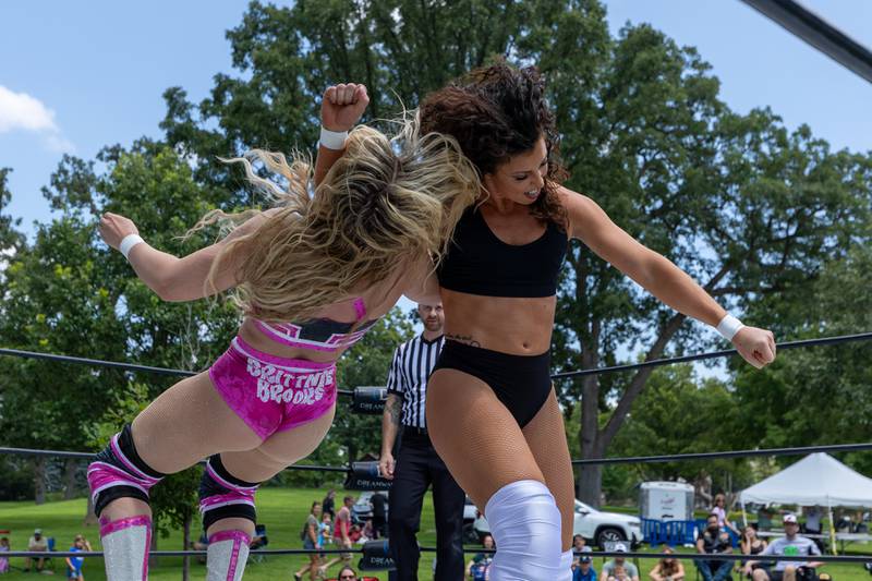 (left to right) Brittnie Brooks gets clotheslined by J-Rod at the Taste of the Illinois Valley DreamWave Wrestling event on Saturday, August 2, 2025 at Centennial Park in Peru.