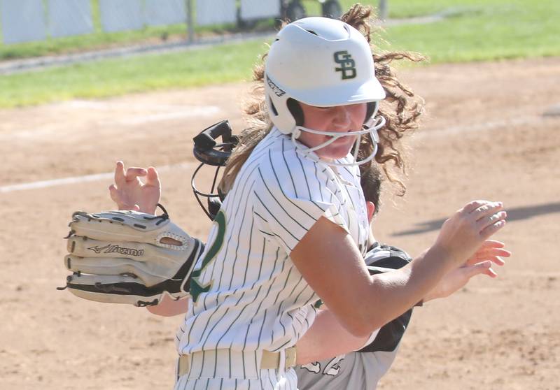 St. Bede's Ella Hermes collides with Woodland/Flanagan-Cornell's Kaylee Henert while running to first base on Monday, April 29, 2024 at St. Bede Academy.