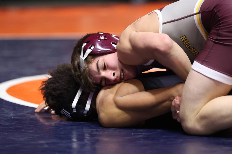 Richmond-Burton’s Emmett Nelson works over Harrisburg’s Tony Keene in the Class 1A 113lb. semifinals at State Farm Center in Champaign. Friday, Feb. 18, 2022, in Champaign.