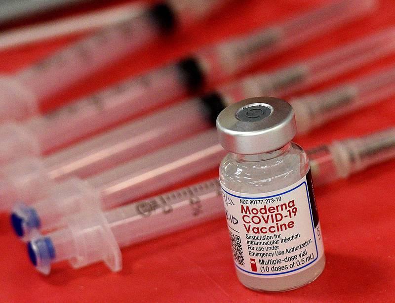 FILE - Syringes and a vial of the Moderna COVID-19 vaccine are displayed at a mass COVID-19 vaccination site in Batavia, Ill., on March 19, 2021.
