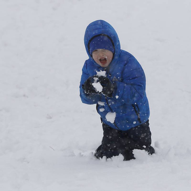 Conrad Tuttle, 6, of Port Barrington, eats fresh snow Wednesday, Jan. 25, 2023, while sledding with other children at Veteran Acres Park in Crystal Lake. Snow fell throughout the morning, leaving a fresh blanket of snow in McHenry County.