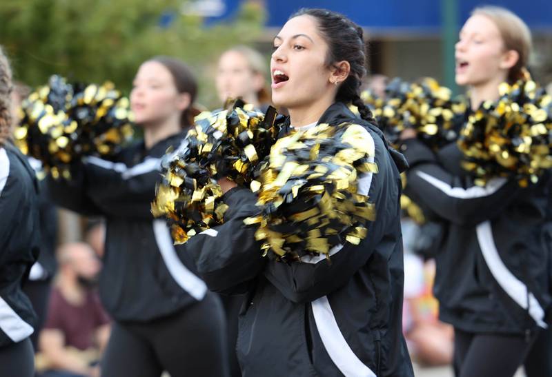 The Sycamore High School Cheer Team makes its way through downtown Sycamore Wednesday, Oct. 5, 2022, during the school's homecoming parade.