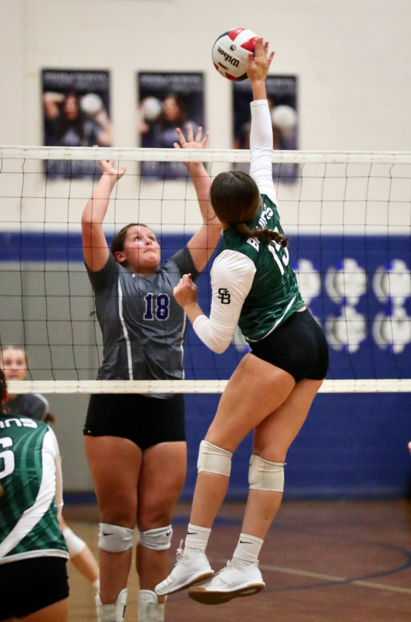 St. Bede's Bella Pinter takes a hit against Princeton's Morgan Richards Monday night at Prouty Gym.