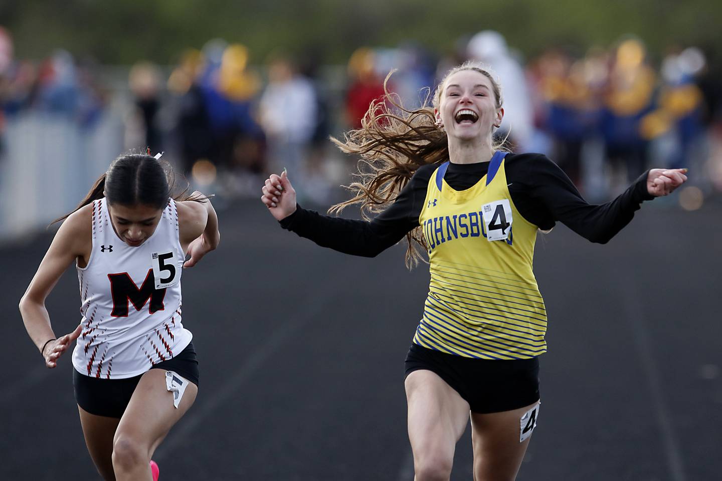Johnsburg’s Caitlyn Casella wins the 100 meter dash Friday, April 21, 2023, during the McHenry County Track and Field Meet at Cary-Grove High School.