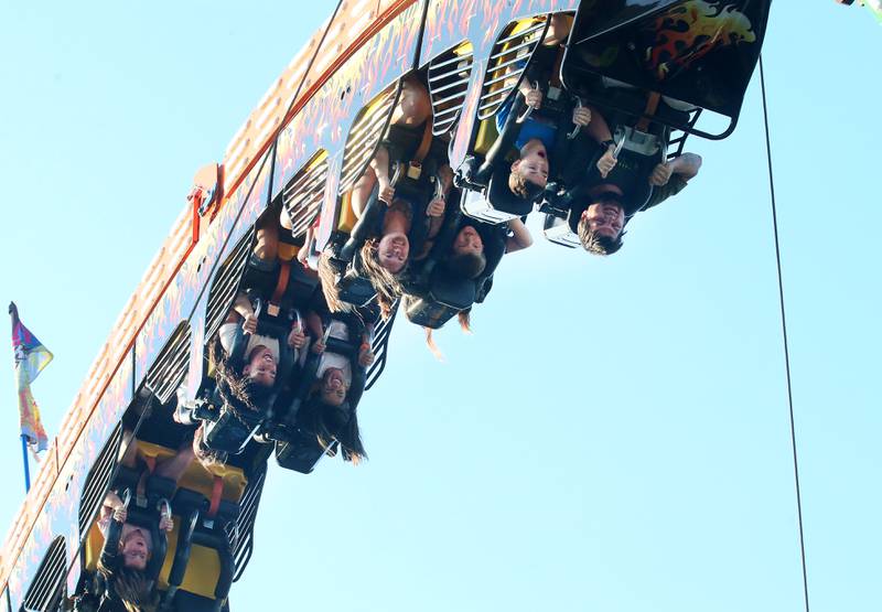 Kids hang upside down while riding the Fireball carnival ride during Spring Valley Summerfest on Thursday, June 19, 2025 downtown Spring Valley. The festival features a carnival, live entertainment, food vendors and fireworks on Saturday at dusk.