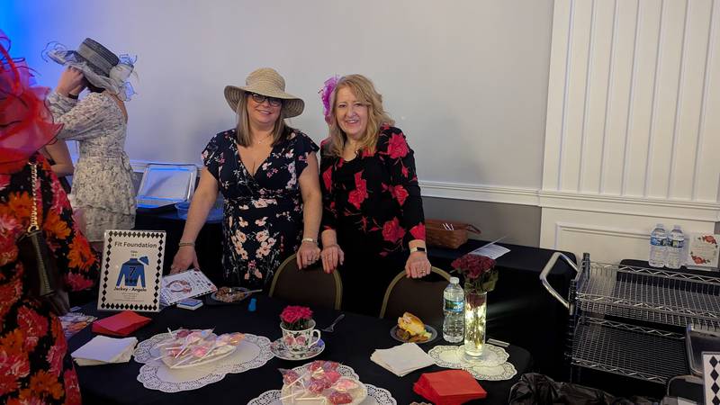Michelle Aegerter of Crest Hill, sister of Angie Aegerter, owner of the Fit Foundation in Creet Hill, poses with Linda Slabaugh of Joliet behind the Fit Foundation table at the Shorewood HUGS chocolate ball on Saturday, February 1, 2025, in Joliet.