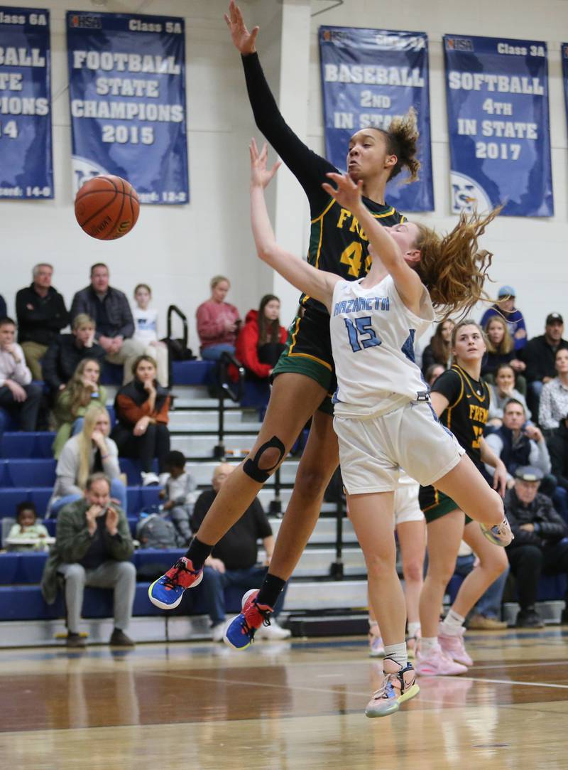 Fremd's Kace Urlacher (44) and Nazareth's Mary Bridget Wilson (15) get tangled up during the girls varsity basketball game between Fremd and Nazareth on Monday, Jan. 9, 2023 in La Grange Park, IL.