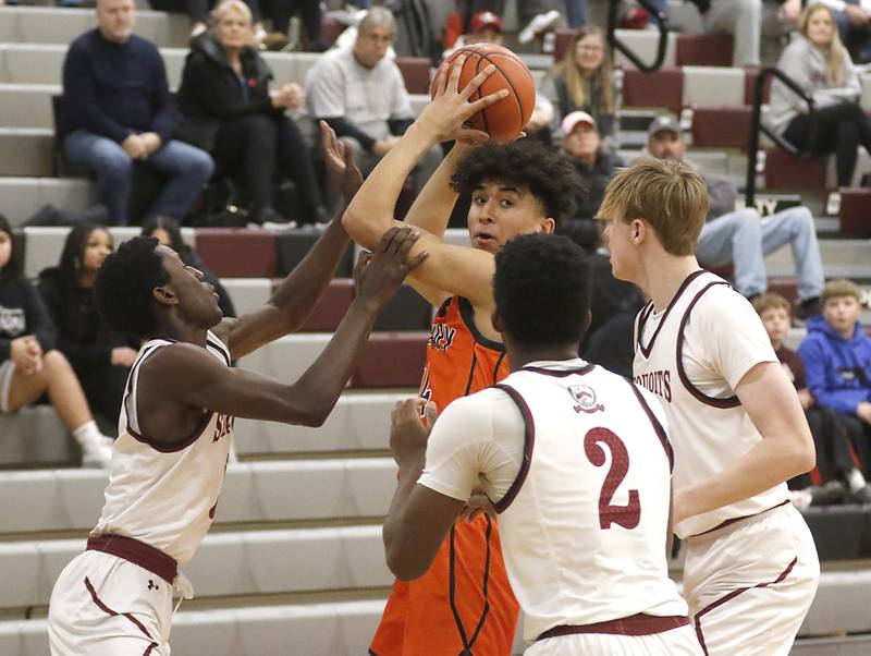 McHenry's Adam Anwar looks to pass as he is triple-teamed by Antioch’s Teddi Wetu, Marshall Gehrke, and John Majerowski during a nonconference basketball game Thursday, Jan. 4. 2024, at Antioch High School.