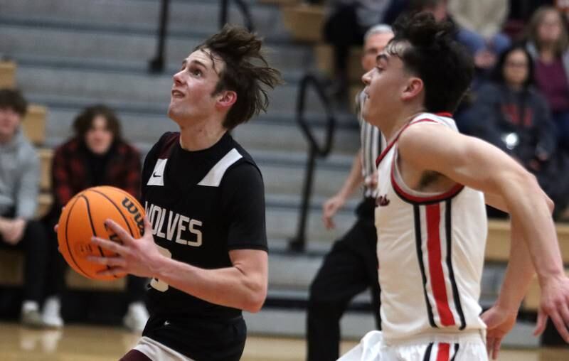 Prairie Ridge’s Rory Rezendes, left, drives past Huntley’s Christian Wilson in varsity boys basketball on Tuesday, Feb. 18, 2025, at  Huntley High School in Huntley.