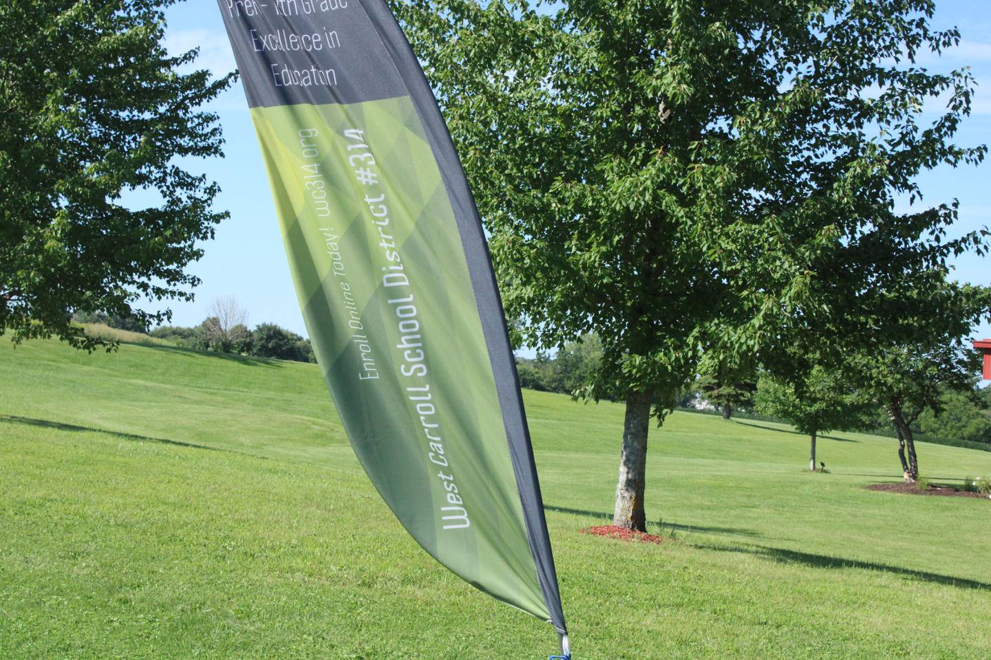 A West Carroll School District banner flutters in the breeze in this file photo from Aug. 16, 2022.