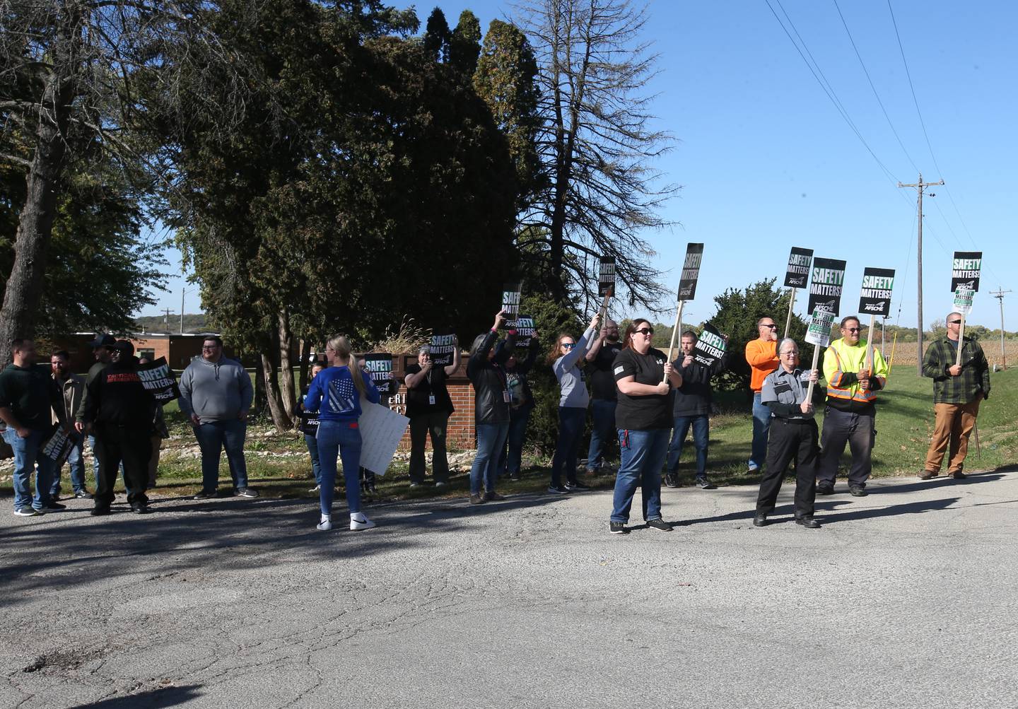 Sheridan Correctional Center employees hold signs saying "Safety matters, say 'no' to drug smuggling say 'no' to assaults on staff during a picket protest on Thursday, Oct. 17, 2024 outside the Sheridan Correctional Center in Sheridan.