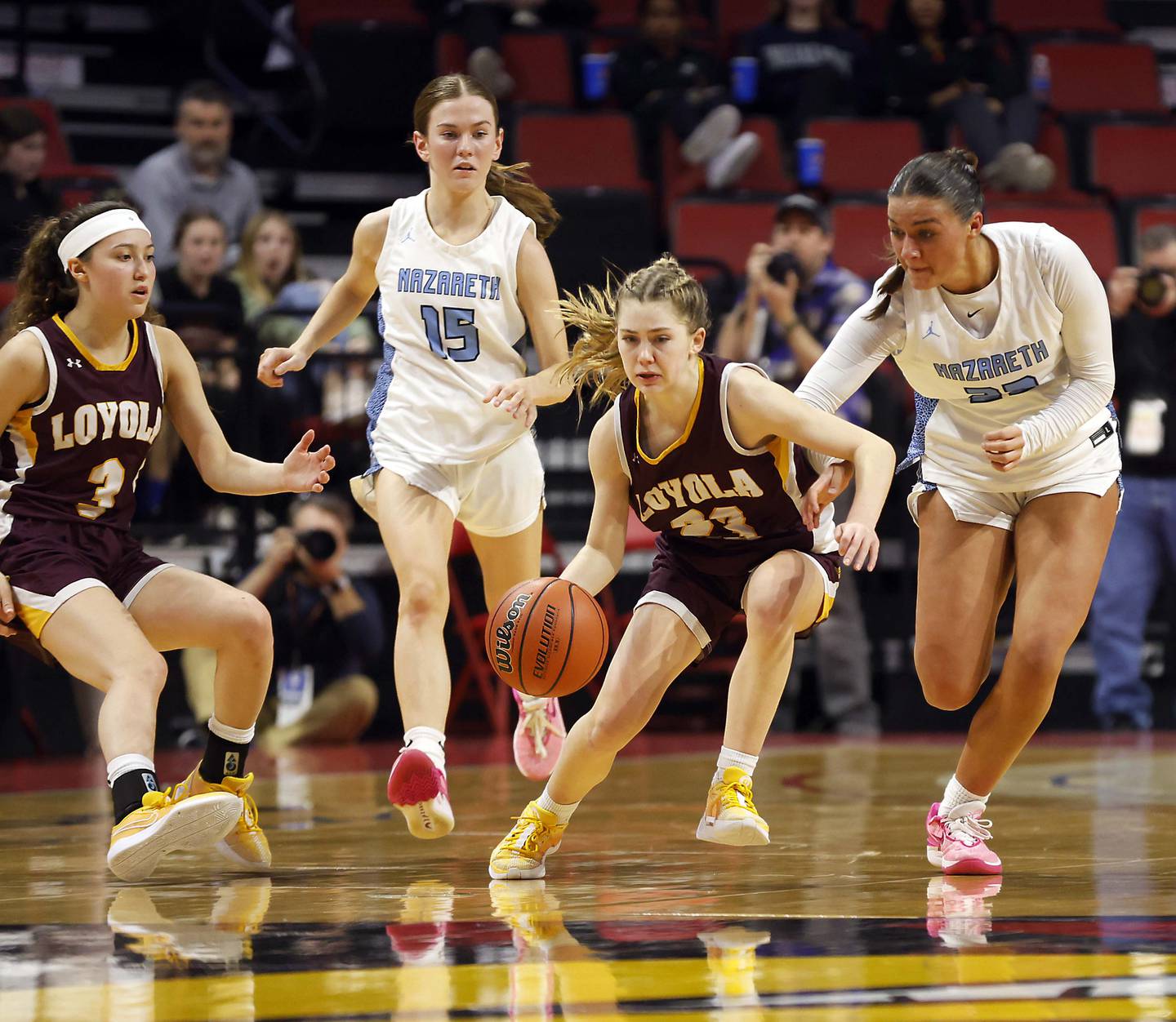 Loyola Academy's Marycait Mackie (23) brings the ball up court as Nazareth Academy's Danielle Scully (23) and Mary Bridget Wilson (15) pressure her during the IHSA Class 4A Girls Basketball championship game Saturday, March 2, 2024 at the CEFCU Arena in Normal.