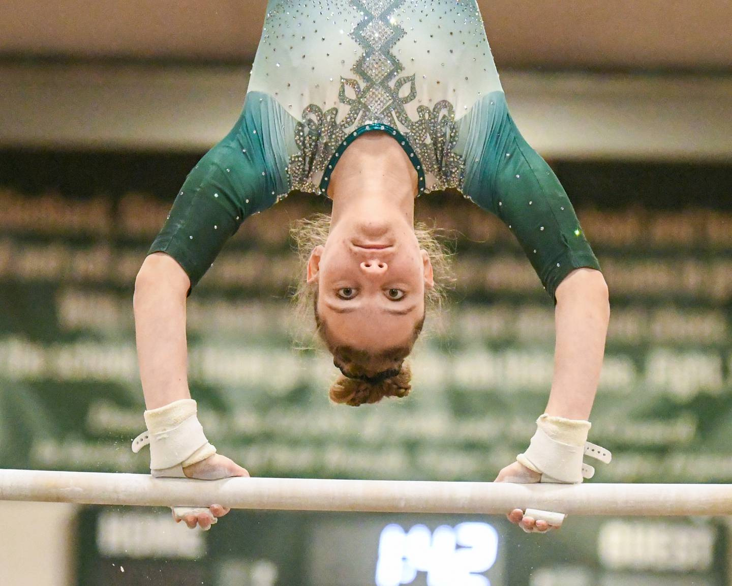 Grace Flint of Glenbard West compete in the uneven bars on Saturday Jan. 27, 2024, during the conference meet held at Glenbard West.