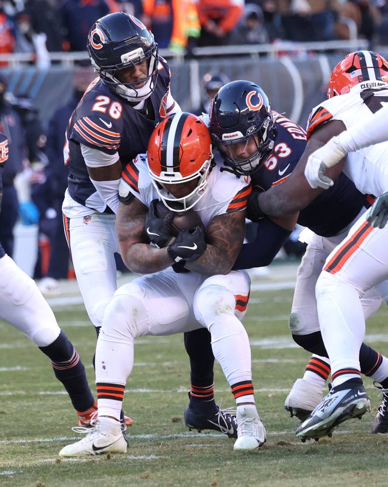 Chicago Bears cornerback Nahshon Wright (left) and linebacker T.J. Edwards bring down Cleveland Browns running back Quinshon Judkins during their game Sunday, Dec. 14, 2025, at Soldier Field in Chicago.