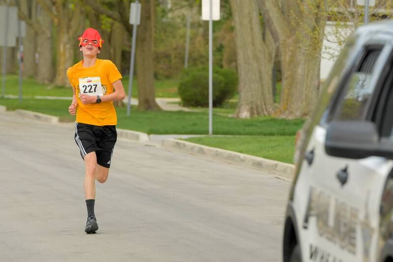 Giancarlo Pietrasanta, 13 runs the home stretch of the for the win with a personal record of 17:46 during the Super Hero 5k Fun Run in Wheaton on Saturday, April 15, 2023.