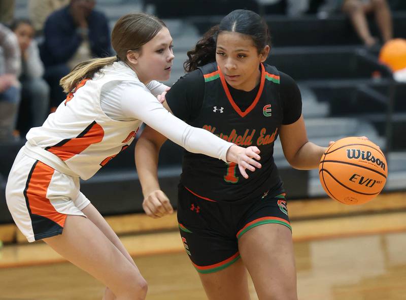 Plainfield East's Khloe Oglesby trives past DeKalb's Emma Craig Thursday, Feb. 12, 2026, during their game at DeKalb High School.