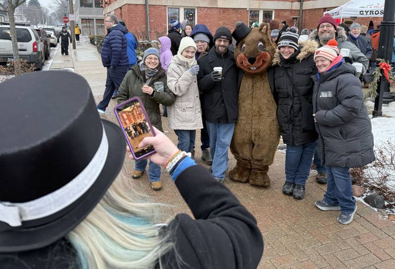 Woodstock Willie poses for photos with the crowd on Monday, Feb. 2, 2026, during the annual Groundhog Day Prognostication in the Woodstock Square.