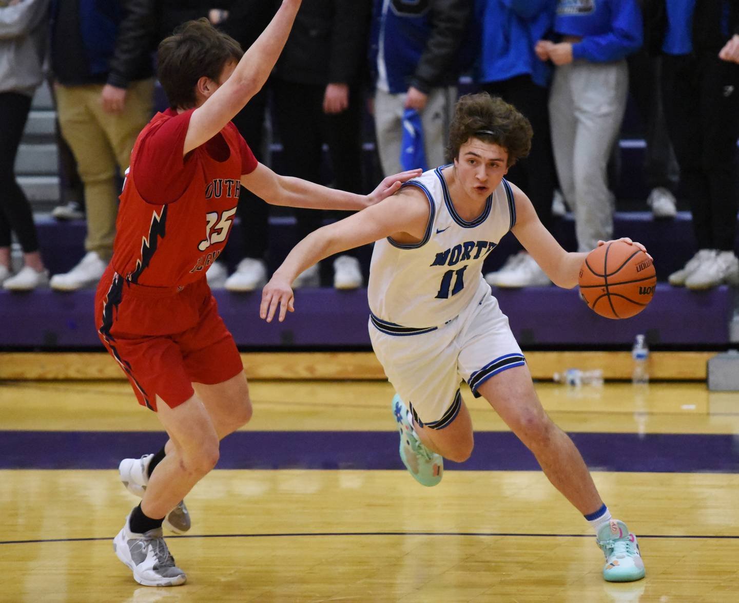 St. Charles North's Brady Rasso (11) drive around South Elgin's Michael Hankins during WednesdayÕs Class 4A Hampshire regional semifinal boys basketball game.