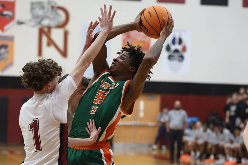 Plainfield East’s Alijah Little takes the contested shot against Plainfield North on Tuesday, Dec. 9, 2025 in Plainfield.