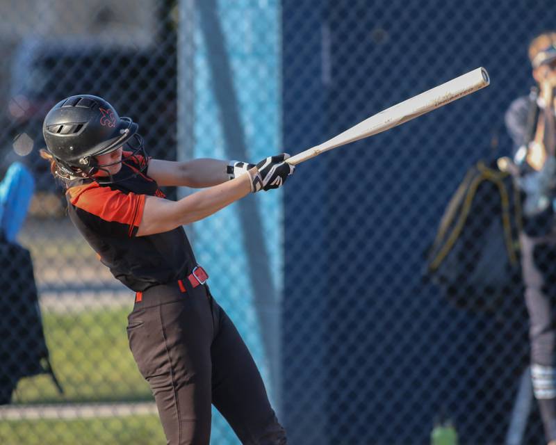St Charles East's Hayden Sujack (21) connects on a pitch during varsity softball game between St Charles East at Downers Grove South.  April 12, 2023.
