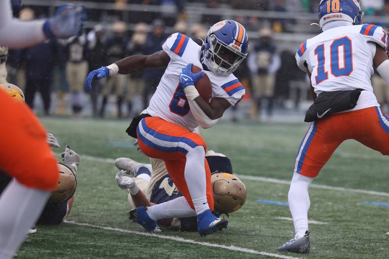 East St. Louis’ Taryan Martin avoids a tackle on a run against Lemont in the Class 6A semifinal in Lemont on Saturday.