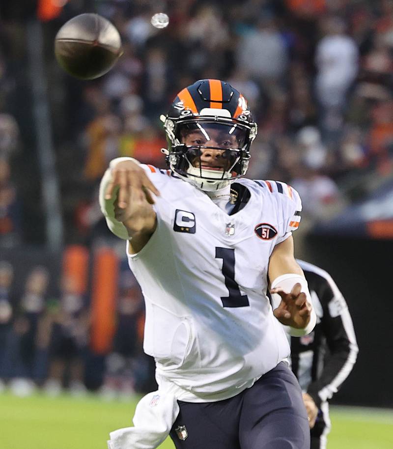 Chicago Bears quarterback Justin Fields throws a touchdown pass to tight end Marcedes Lewis during their game against the Arizona Cardinals Sunday, Dec. 24, 2023, at Soldier Field in Chicago.