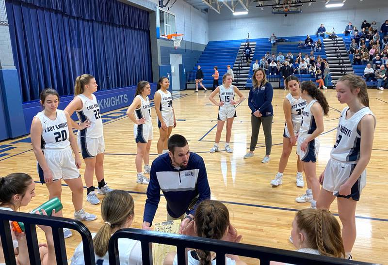 Fieldcrest girls basketball head coach Mitch Neally (center) gives his starting five last-minute instructions during pregame introductions Saturday, Jan. 28, 2023, in Minonk.