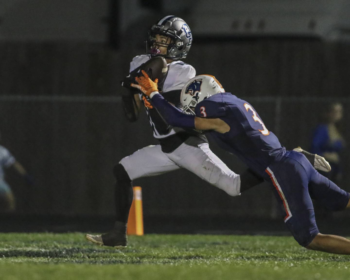 Oswego East's Donavin Eason (16) comes down with a long touchdown reception off of a scramble by Nicko Villacci (5) during football game between Oswego East at Oswego Friday, Oct 17, 2025 in Oswego.