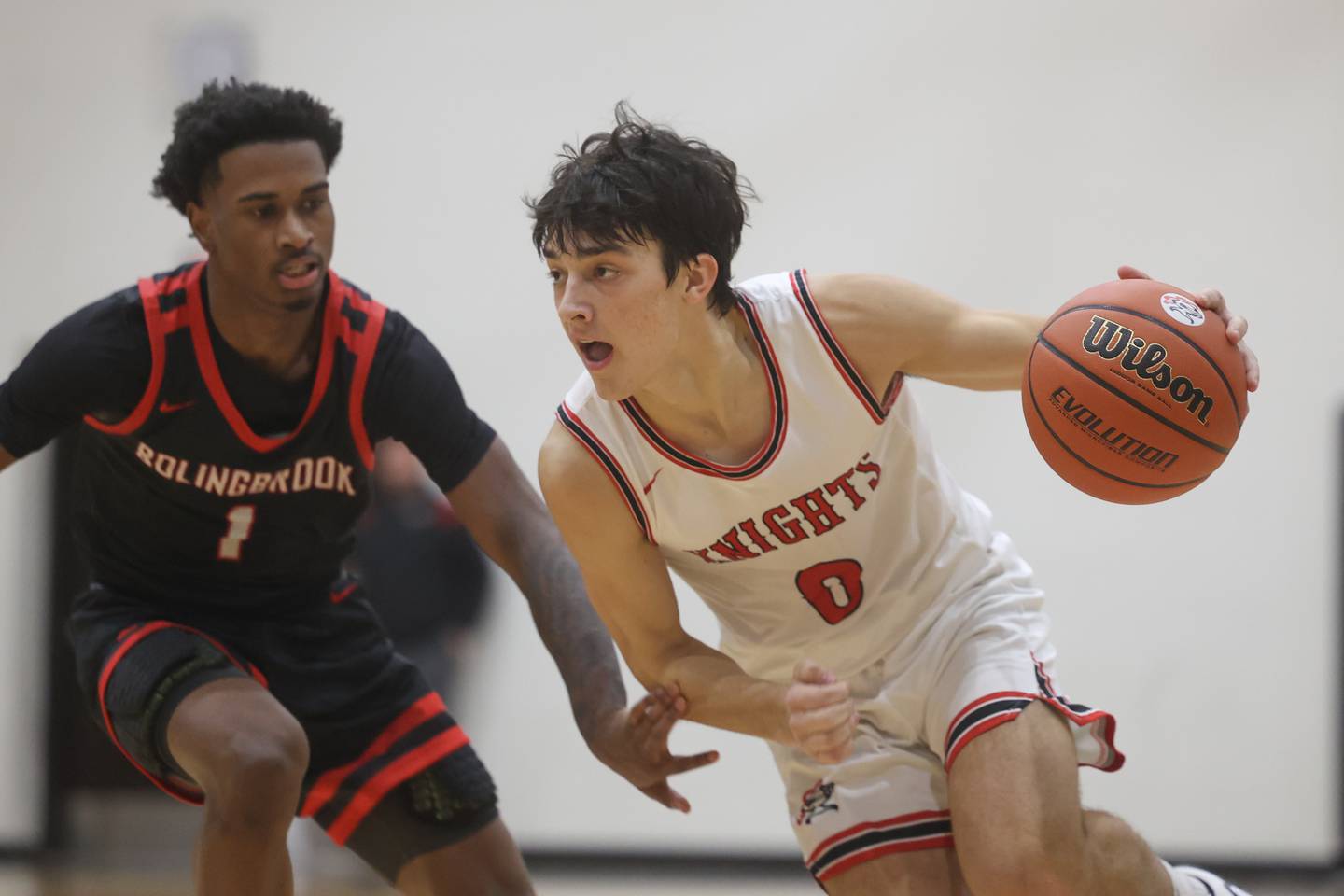 Lincoln-Way Central’s Ben McLaughlin drives around  Bolingbrook’s Mekhi Cooper.