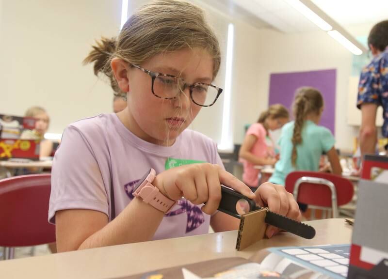 Rileigh cuts a piece of cardboard to use for a project during the Camp Invention on Wednesday, ?June 5, 2024 at Central Intermediate School in Ottawa. For over 30 years, the National Inventors Hall of Fame has inspired millions of chldren through it's flagship summer program. The weeklong program is led by qualified local educators in the Ottawa area along with local high schoolers volunteering. The camp is for students from kindergarten through sixth grades. Donations were made possible from Covia, US Silica, CAVIC, Financial Plus, Pilkington and community members. With the help of donations,  A total of 74 students were able to participate in this years camp.