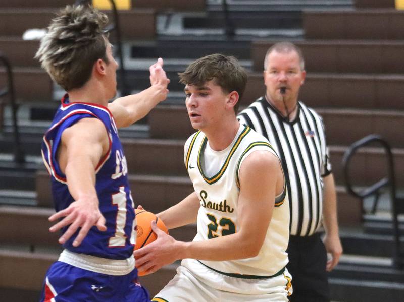 Lakes’ Aidan Hopkins, left, glides in to cover Crystal Lake South’s Nick Stowasser in varsity boys basketball Hinkle Holiday Classic action on Friday, Dec. 26, 2025, at Jacobs High School in Algonquin.