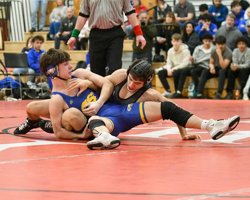 Demetrios Carrera, right, of Marmion Academy keeps a hold of Sandburg wrestler Madden Parker during the 138-weight class during the regional meet on Tuesday Feb. 25, 2025, held at Yorkville High School.