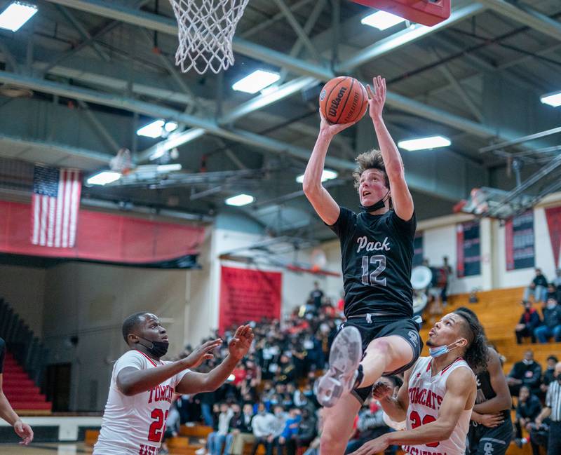 Oswego East's Ryan Johnson (12) shoots the ball in the post against East Aurora during the 11th Annual Kivisto Hoopfest at East Aurora on Saturday, Feb 5, 2022.