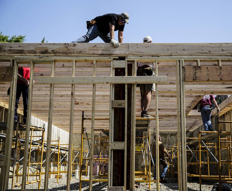 Volunteers work on a Habitat for Humanity house on Summit Street in Joliet on Thursday. The city partnered with the Will County Habitat for Humanity to provide federal funds to assist in the building of the home.