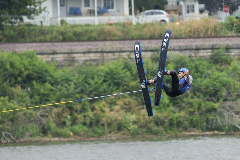 A Ski Broncs Water Ski team member soars through the air during a flip off of a ramp in the middle of the Rock River Saturday, July 16, 2022. Fans sat on the banks of the river in Sewards park and water the group perform a variety of stunts and tricks.