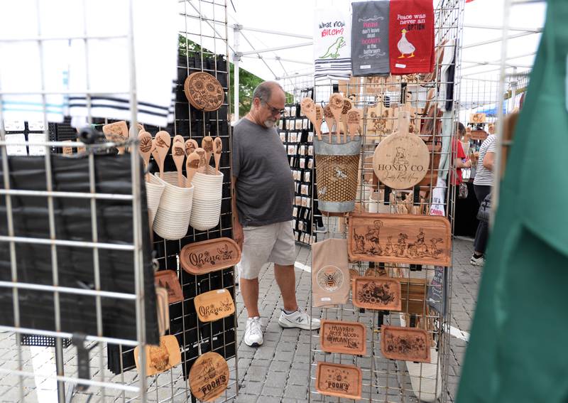 Joe De Monte of Berwyn looks over kitchen supplies while attending the annual La Grange Craft Fair Saturday July 12, 2025.