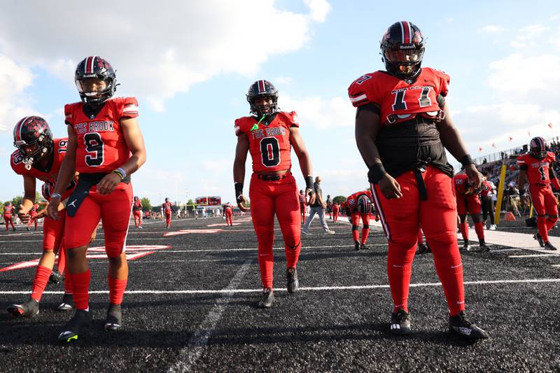 Bolingbrook’s Jayden Lawrence (9), Joshua Robinson (0) and Isaac Amoh warm up before the game against Minooka. Friday, Aug. 26, 2022, in Bolingbrook.