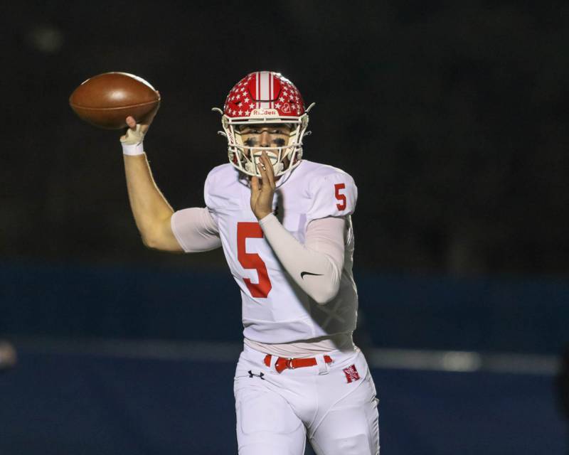 Naperville Central's Sebastian Hayes (5) unleashes a sideline pass during Class 8A quarterfinal football game between Naperville Central at Lyons on Friday, Nov 15, 2024  in Western Springs.