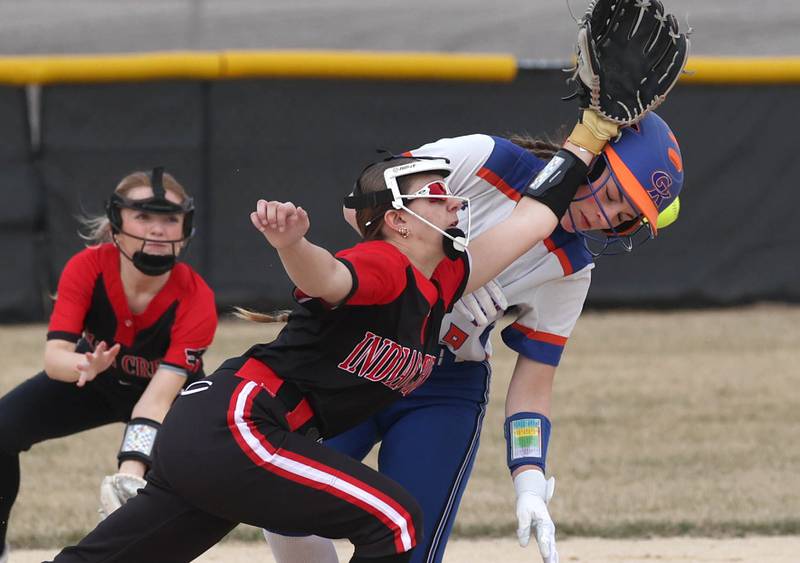Indian Creek’s MaKenna Barshinger collides with Genoa-Kingston’s Olivia Vasak on a steal attempts as the ball goes into center field during their game Tuesday, March 18, 2025, at Indian Creek High School in Shabbona.