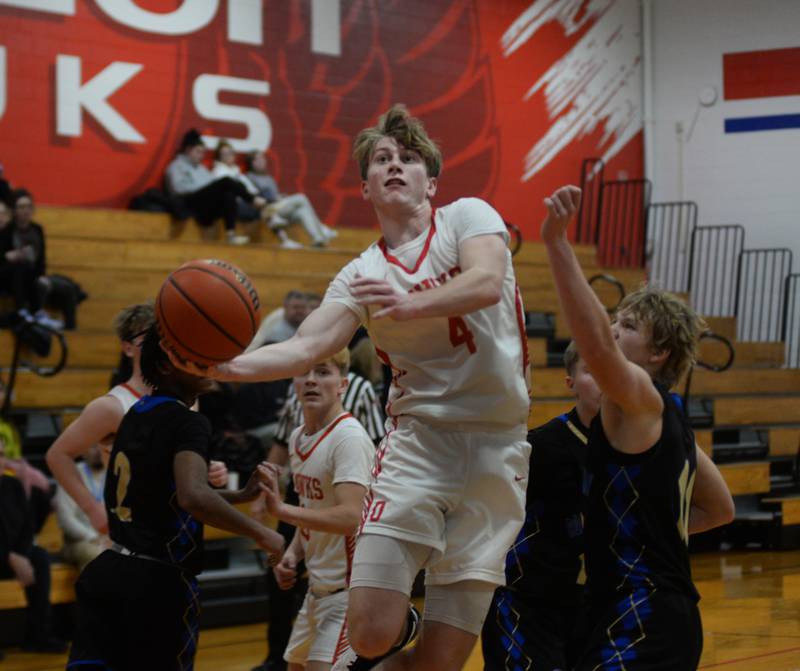 Oregon's Jameson Caposey (4) drives to the bucket past Rockford Christian defenders during the third place game at the Oregon Thanksgiving Tournament on Saturday, Nov. 25, 2023 in Oregon.