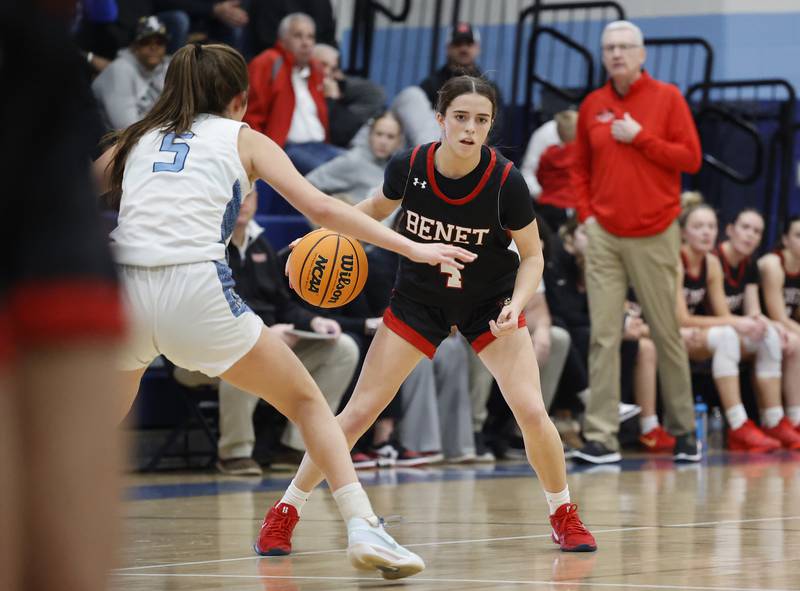 Benet's Ava Mersinger (4) looks for an opening during a girls varsity basketball game between Benet and Nazareth academies on Saturday, Dec. 14, 2024 in La Grange Park.