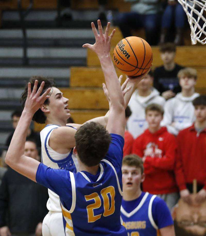 Woodstock's Collin Greenlee drives to the basket against Johnsburg's Josh Kaunas during a Kishwaukee River Conference basketball game on Friday,  Feb. 14, 2025, at Woodstock High School.