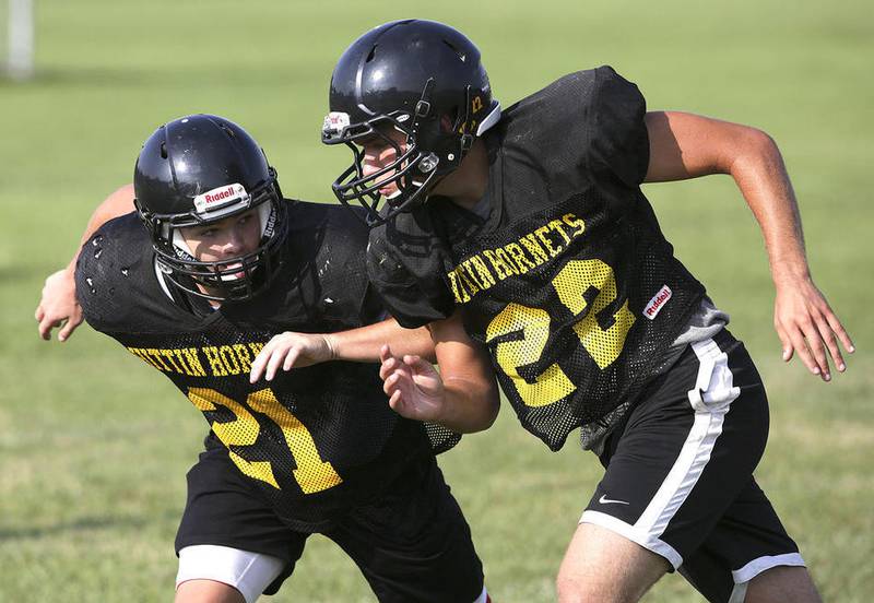 Liam Joyce (left) covers Hunter Freres ,22, during a drill during football practice at Harvard High School on Friday, August 11, 2016 in Harvard.
