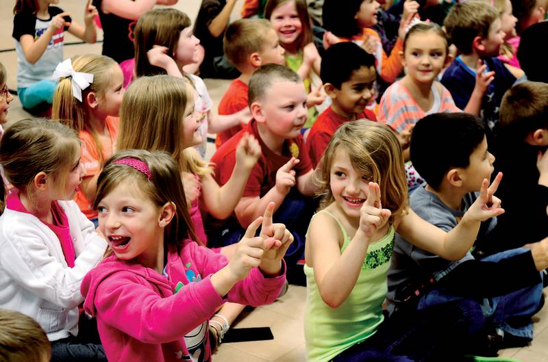 Students at Franklin School in Sterling practice magic tricks March 23, 2012 during an anti-bully program by motivational speaker Jim Jelinske.