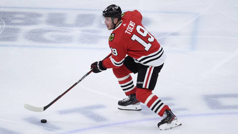 FILE - Chicago Blackhawks' Jonathan Toews (19) moves the puck down ice during the third period of an NHL hockey game against the San Jose Sharks on Jan. 1, 2023, in Chicago. Chicago captain Jonathan Toews and forward Patrick Kane are contemplating their futures ahead of the NHL trade deadline on March 3. (AP Photo/Paul Beaty, File)