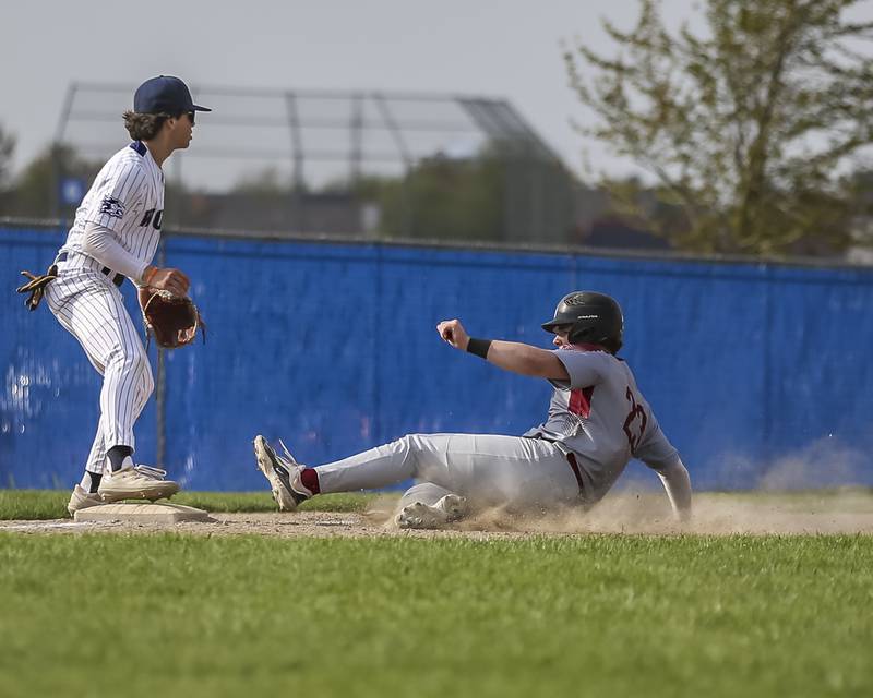 Plainfield North's Logan Huegel (23) slides into third during baseball game between Plainfield North at Oswego East, Monday, April 28, 2025 in Oswego.