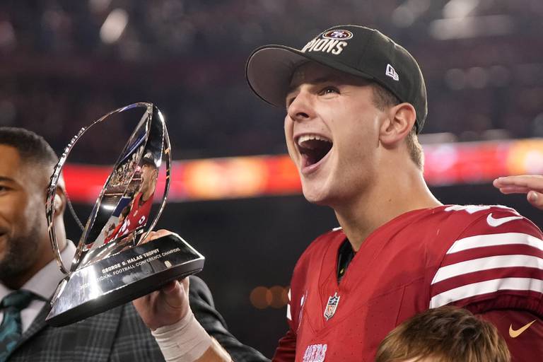 San Francisco 49ers quarterback Brock Purdy celebrates with the George S. Halas Trophy after their win against the Detroit Lions in the NFC Championship game in Santa Clara, Calif., Sunday, Jan. 28, 2024.