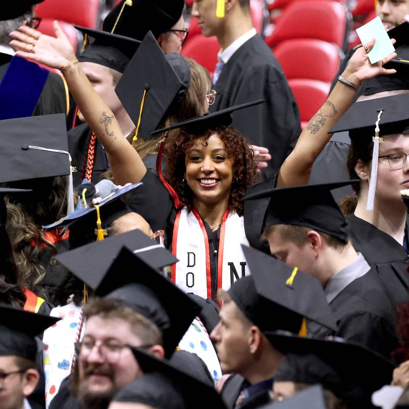 A Northern Illinois University candidate for graduation celebrates as the students are seated during the first of two undergraduate commencement ceremonies Saturday, May 11, 2024, in the Convocation Center at NIU in DeKalb.