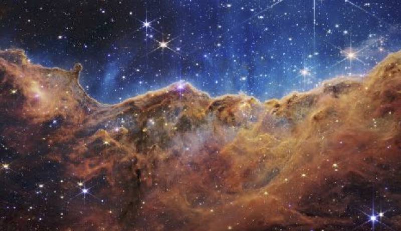 This image from NASA shows the edge of a nearby, young, star-forming region called NGC 3324 in the Carina Nebula. It was captured in infrared light by NASA’s new James Webb Space Telescope. NASA Solar System Ambassador Joel Knapper will discuss this and other images from the Webb Space Telescope at the next Northern Illinois University STEM Cafe.